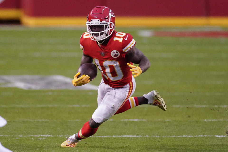 Kansas City Chiefs wide receiver Tyreek Hill runs up field after catching a pass during the second half of an NFL divisional round football game against the Cleveland Browns, Sunday, Jan. 17, 2021, in Kansas City. The Chiefs won 22-17. (AP Photo/Charlie Riedel)