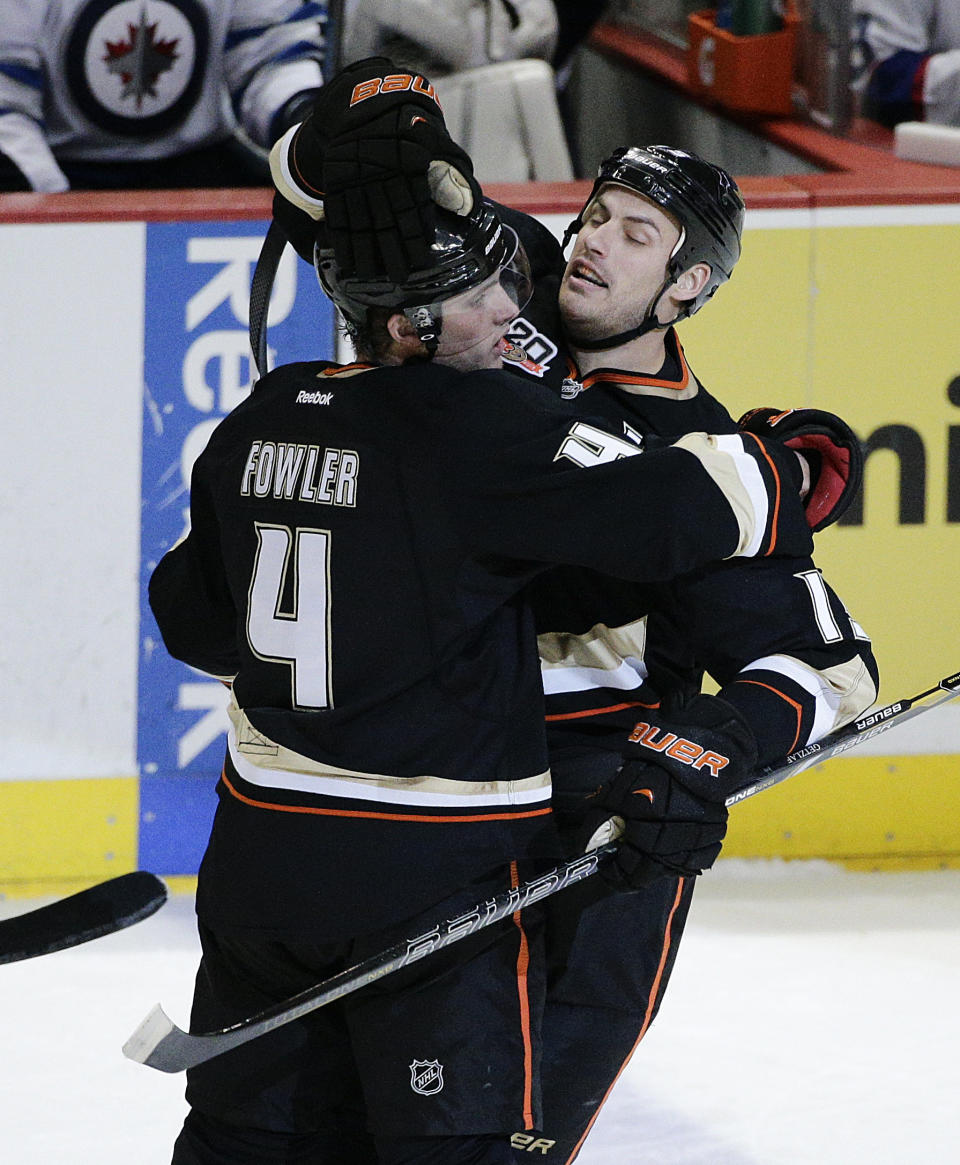 Anaheim Ducks' Cam Fowler, left, and Ryan Getzlaf celebrate a goal by Fowler during the first period of an NHL hockey game against the Winnipeg Jets, Tuesday, Jan. 21, 2014, in Anaheim, Calif. (AP Photo/Jae C. Hong)