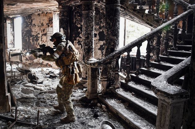 A Russian soldier patrols at the Mariupol drama theatre on April 12, 2022 in Mariupol, Ukraine. This picture was taken during a trip organized by the Russian military. (Photo: Alexander Nemenov/AFP via Getty Images)
