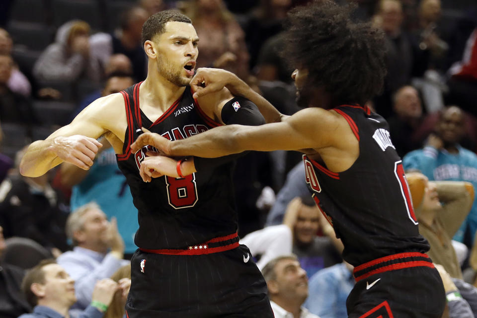 Chicago Bulls' Zach LaVine (8) celebrates his winning three-point basket with teammate Coby White (0) during the second half of an NBA basketball game i against the Charlotte Hornets in Charlotte, N.C., Saturday, Nov. 23, 2019. (AP Photo/Bob Leverone)