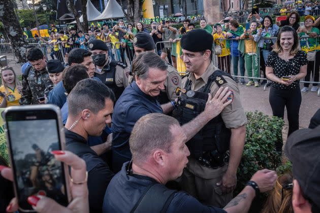 Brazilian President Jair Bolsonaro salutes a policeman during a campaign rally at Praça da Liberdade in Belo Horizonte in Minas Gerais State on Aug. 24. (Photo: Photo by Ivan Abreu/SOPA Images/LightRocket via Getty Images)