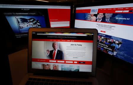 The websites of the three largest Political Action Committee (PAC) groups supporting U.S. President Donald Trump and his agenda, including (L-R) the sites of "America First Policies", "Committee to Defend the President" and "Great America PAC" are seen on computer screens in this photo illustration taken in Washington, U.S., June 27, 2017. REUTERS/Jim Bourg/Illustration