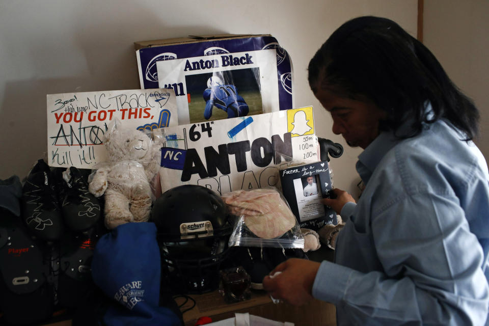 FILE - In this Jan. 28, 2019 file photo, Jennell Black, mother of Anton Black, looks at a collection of her son's belongings at her home in Greensboro, Md. Anton Black, 19, died after a struggle with three officers and a civilian outside the home in September 2018. Cases involving police use of force often include questions about the internal records of the officers involved, records that in most cases are off-limits to the press and public. Lawmakers in at least 13 states have considered bills this year to make those records more publicly available. (AP Photo/Patrick Semansky, File)