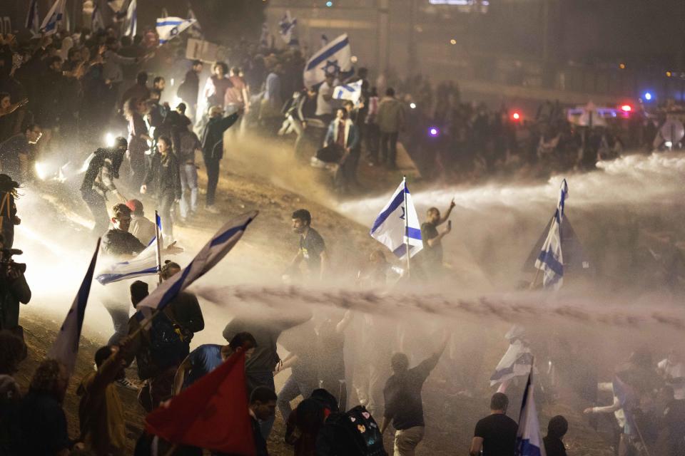 Tens of thousands of Israelis have poured into the streets across the country in a spontaneous outburst of anger after Prime Minister Benjamin Netanyahu abruptly fired his defense minister for challenging the Israeli leader's judicial overhaul plan. (Oren Ziv / AP)