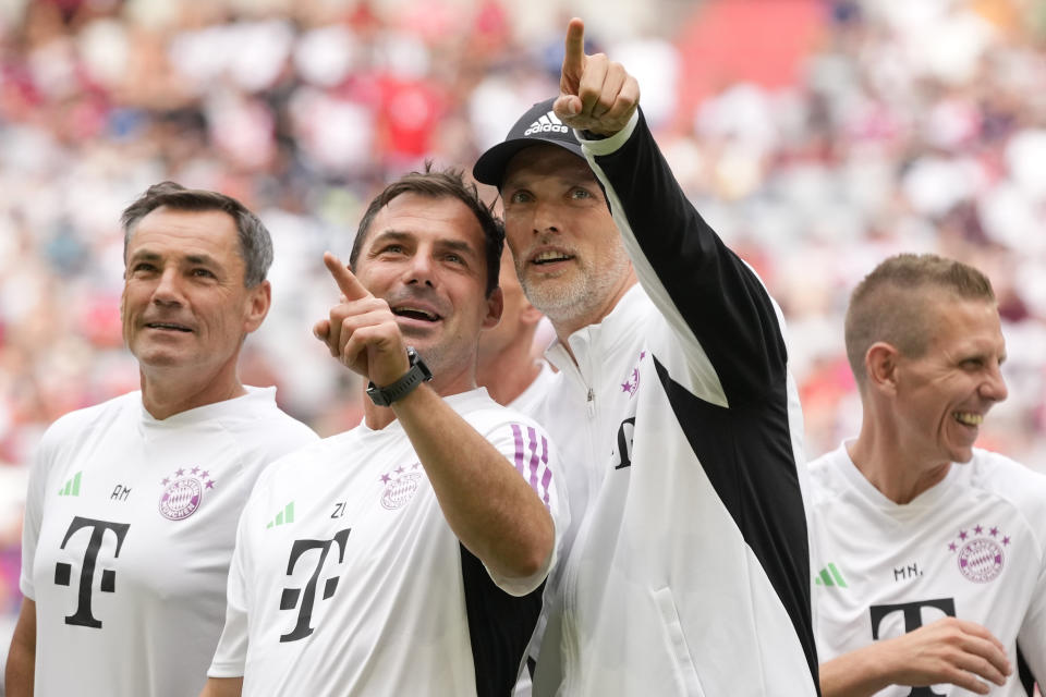 Bayern Munich head coach Thomas Tuchel, front right, points towards spectators in the Allianz Arena stadium in Munich, Germany, Sunday, July 23, 2023, during the team presentation for the upcoming German Bundesliga soccer season. (AP Photo/Matthias Schrader)