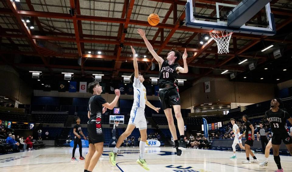 Ripon Christian’s Luke Crivello floats the ball over Futures’ Ivan Blyshchyk for the basket during the Sac-Joaquin Section Division V championship game at UC Davis in Davis, Calif., Friday, Feb. 23, 2024. Andy Alfaro/aalfaro@modbee.com