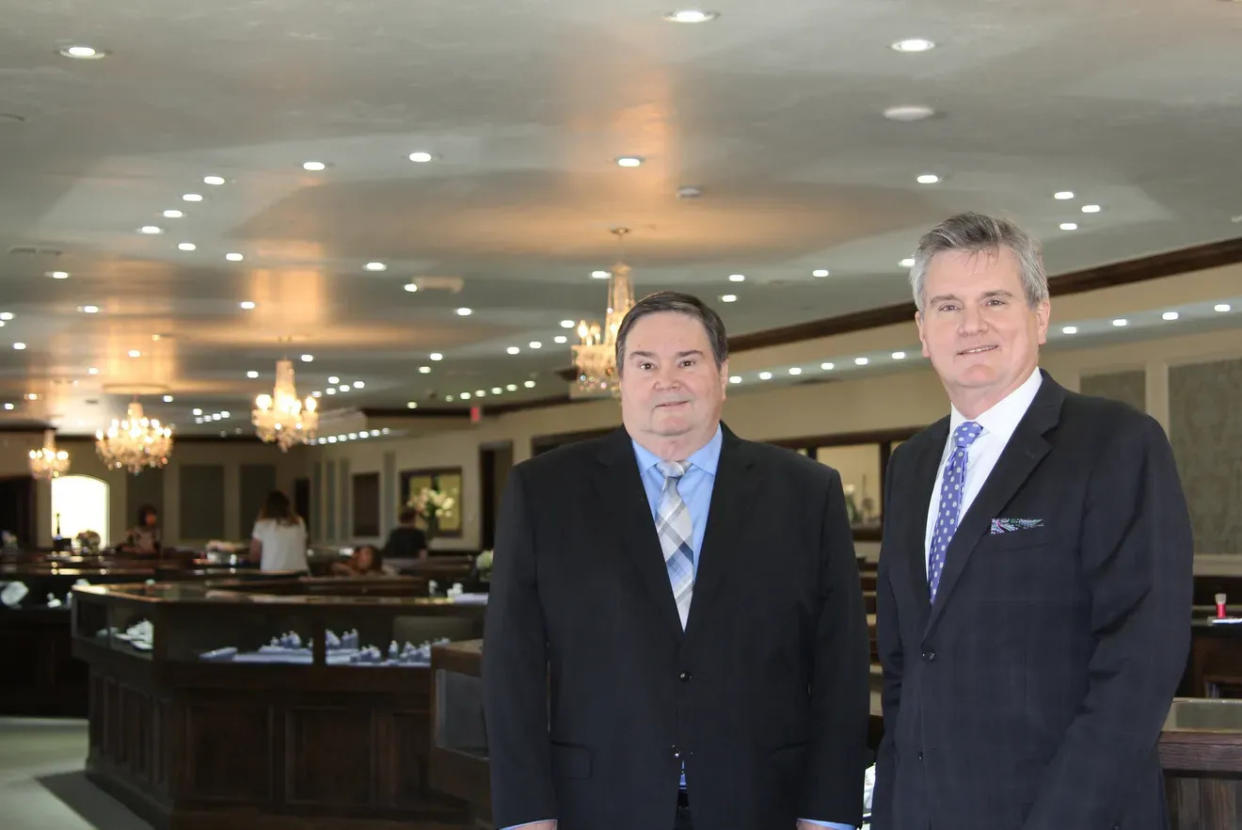Glenn Lewis and his brother and business partner, Tim Lewis, pose inside Lewis Jewelers in 2017.