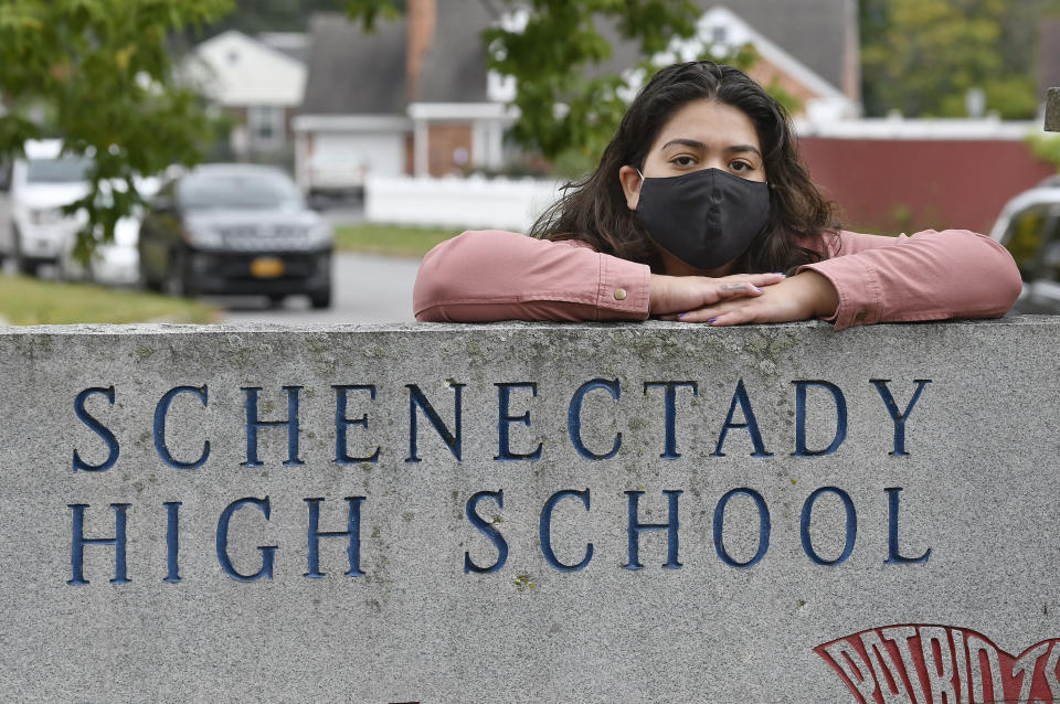 Kristina Negron poses for a photograph Tuesday, Sept. 29, 2020, in Schenectady, N.Y. Negron was laid off from her job as an aide for a special education class at Schenectady High School due to budget cuts. (AP Photo/Hans Pennink)