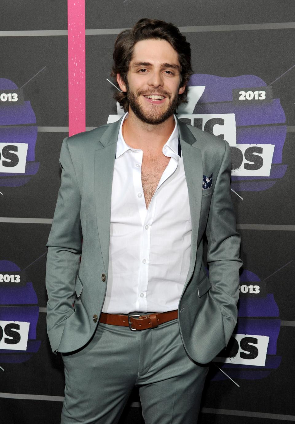 FILE - In this June 5, 2013, file photo, Thomas Rhett arrives at the 2013 CMT Music Awards in Nashville, Tenn. Thomas Rhett, whose full name is Thomas Rhett Akins Jr., grew up in the limelight of his father’s success, even appearing on television and on stage singing songs with his dad, Rhett Akins. The father and son songwriters managed to get credits on five of the top 10 songs on country radio in early October 2013. (Photo by Frank Micelotta/Invision/AP, File)