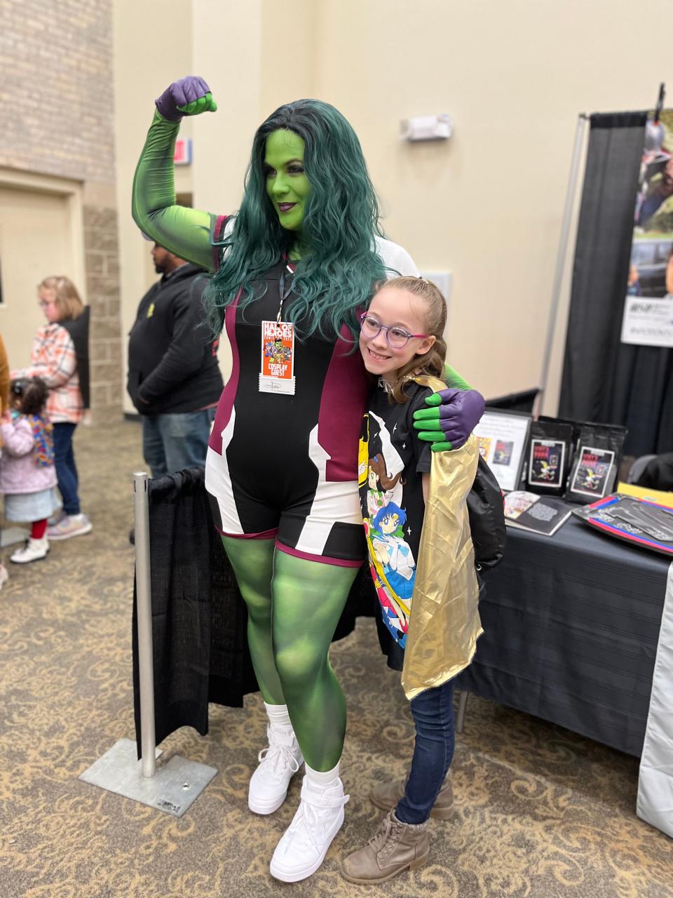 She-Hulk, from the League of Enchantment in Michigan, shows off her strength to Maya York of Elkhart. The League of Enchantment was one of several cosplay groups that use their costume characters to entertain children in hospitals.