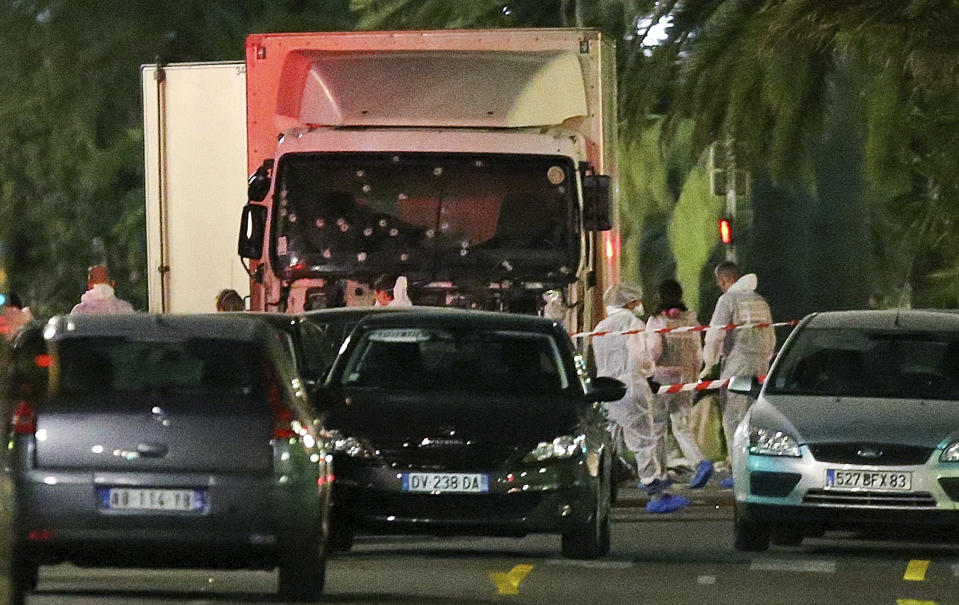 The truck which slammed into revelers late Thursday, July 14, is seen near the site of an attack in the French resort city of Nice, southern France, Friday, July 15, 2016. Eight people go on trial Monday Sept.5, 2022 in a special French terrorism court for alleged roles in helping the attacker who drove a truck into the Nice beachfront on Bastille Day 2016, killing 86 people. (AP Photo/Luca Bruno, File)