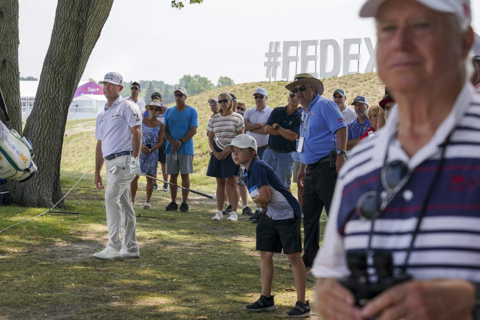 Chez Reavie, left, watches as his shot from the rough lands along the 18th fairway during the second round of the 3M Open golf tournament in Blaine, Minn., Friday, July 23, 2021. (AP Photo/Craig Lassig)