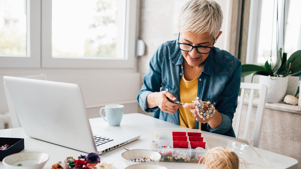 woman making jewelry for her craft work from home job