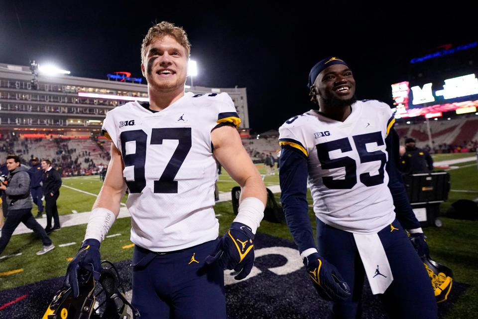 Michigan's Aidan Hutchinson (left) and David Ojabo each have 10 sacks this season.