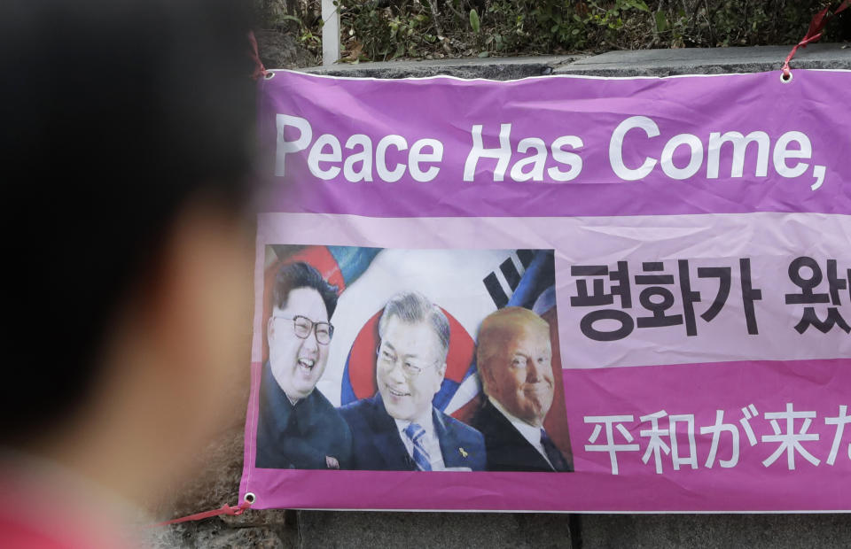 A banner shows images, from left, of North Korean leader Kim Jong Un, South Korean President Moon Jae-in and U.S. President Donald Trump, displayed near U.S. Embassy in Seoul, South Korea, Thursday, April 18, 2019. North Korea said Thursday that it had test-fired a new type of "tactical guided weapon," its first such test in nearly half a year, and a possible sign of its displeasure with deadlocked nuclear talks with the United States. (AP Photo/Lee Jin-man)