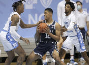 Duke's Patrick Tape (12) is trapped by North Carolina's Armando Bacot (5) and Leaky Black (1) during the first half of an NCAA college basketball game Saturday, March 6, 2021, in Chapel Hill, N.C. (Robert Willett/The News & Observer via AP)