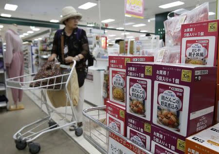 A shopper walks past a shelf displaying Kewpie Corp's nursing care food packages at an Ito-Yokado shopping centre in Tokyo August 5, 2014. REUTERS/Yuya Shino