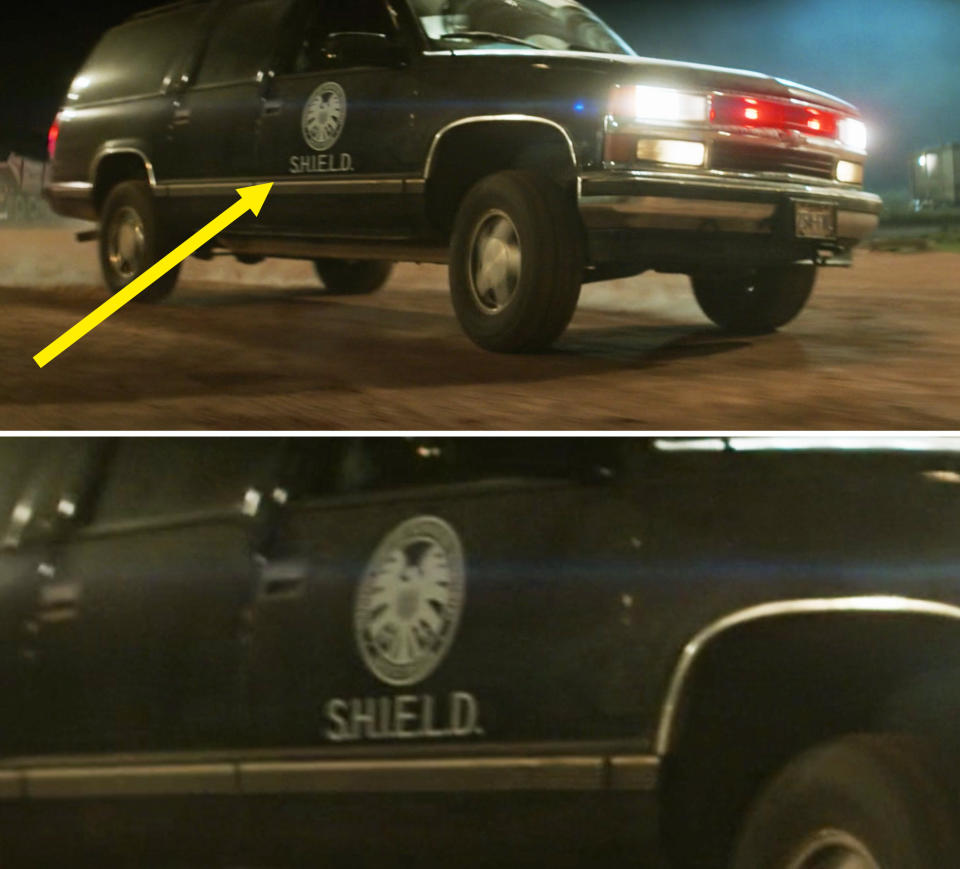 A close-up of a SHIELD logo on a car