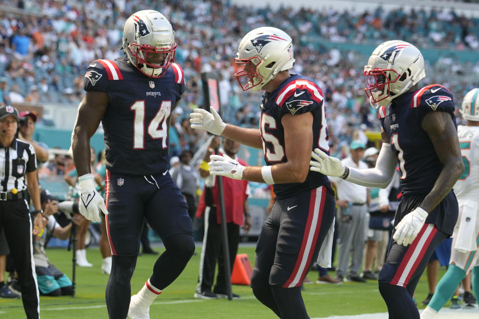 New England Patriots tight end Hunter Henry (85) and wide receiver DeVante Parker (1) congratulate wide receiver Ty Montgomery (14) after Montgomery scored a touchdown during the second half of an NFL football game against the Miami Dolphins, Sunday, Sept. 11, 2022, in Miami Gardens, Fla. (AP Photo/Rebecca Blackwell)