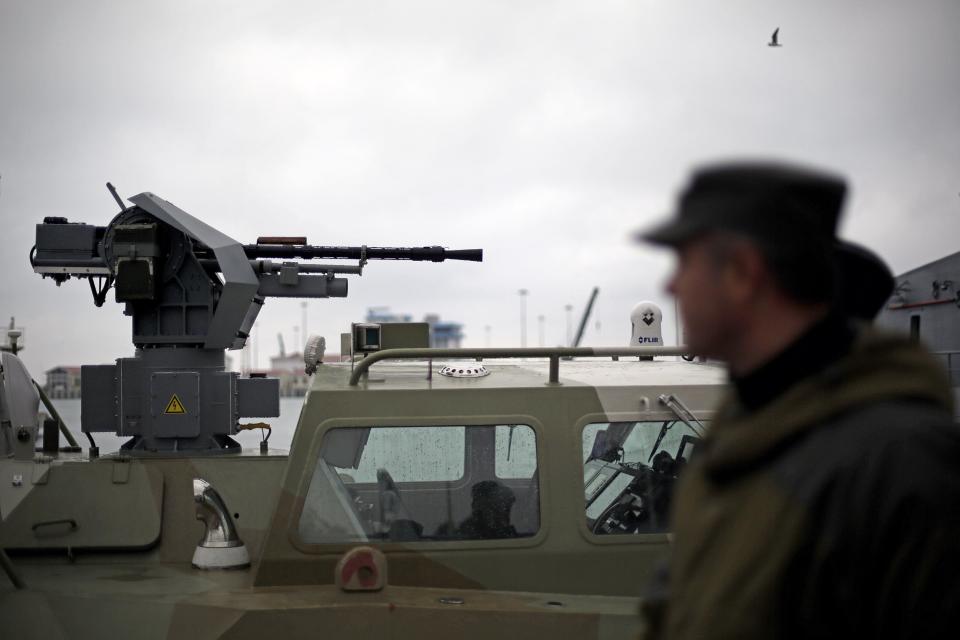 A gun sits atop a Russian military vessel docked in the seaport, Wednesday, Jan. 29, 2014, in Sochi, Russia, home of the upcoming 2014 Winter Olympics. (AP Photo/David Goldman)