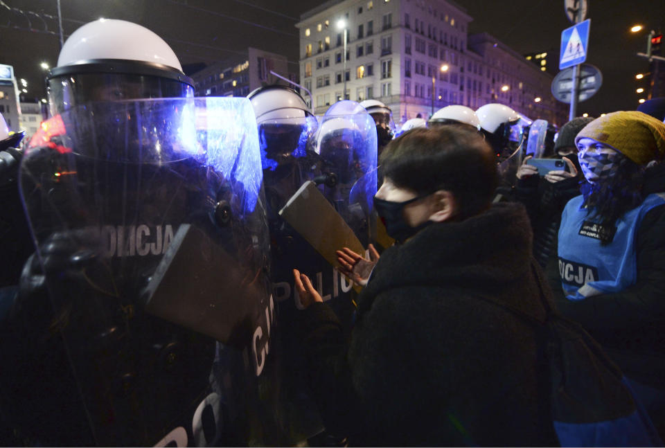 People demonstrate against police violence and an attempted restriction on abortion rights in Warsaw Poland, Saturday, Nov. 28, 2020. Nationwide protests Saturday were scheduled to coincide with Polish women gaining the right to vote 102 years ago. Weeks of protests against a high court's ruling to further restrict Abortion rights have evolved into the largest protest movement since communism fell 30 years ago.(AP Photo/Czarek Sokolowski)