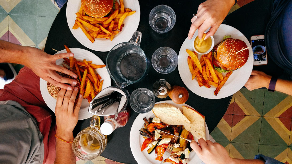 friends eating burgers for lunch together