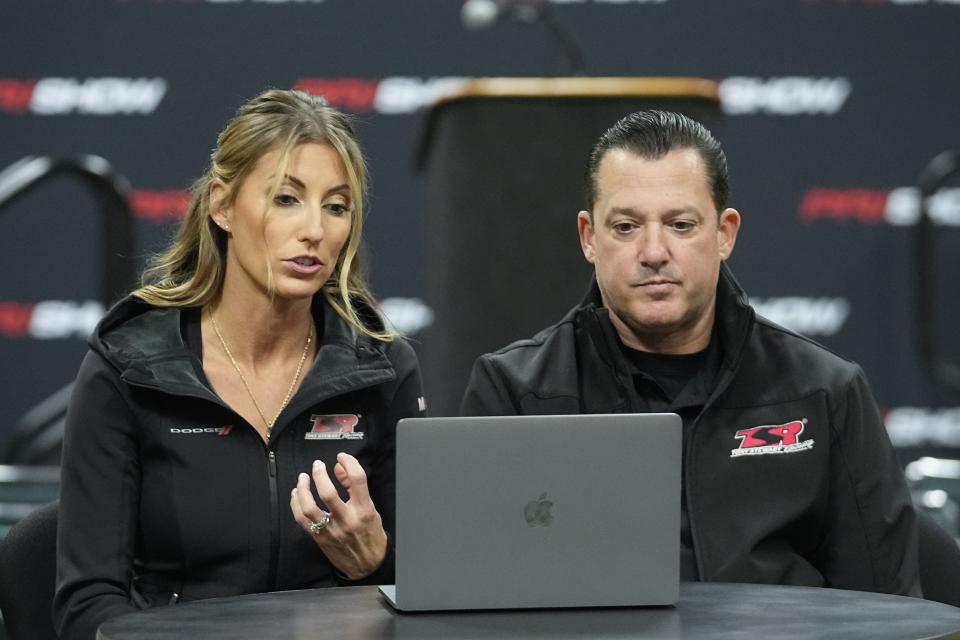 Leah Pruett and her husband Tony Stewart speak during a news conference, Thursday, Dec. 7, 2023, in Indianapolis. Pruett will step away from the NHRA drag racing series in 2024 to focus on starting a family with Stewart. Her NASCAR Hall of Famer husband will replace her next season in the Top Fuel dragster. (AP Photo/Darron Cummings)