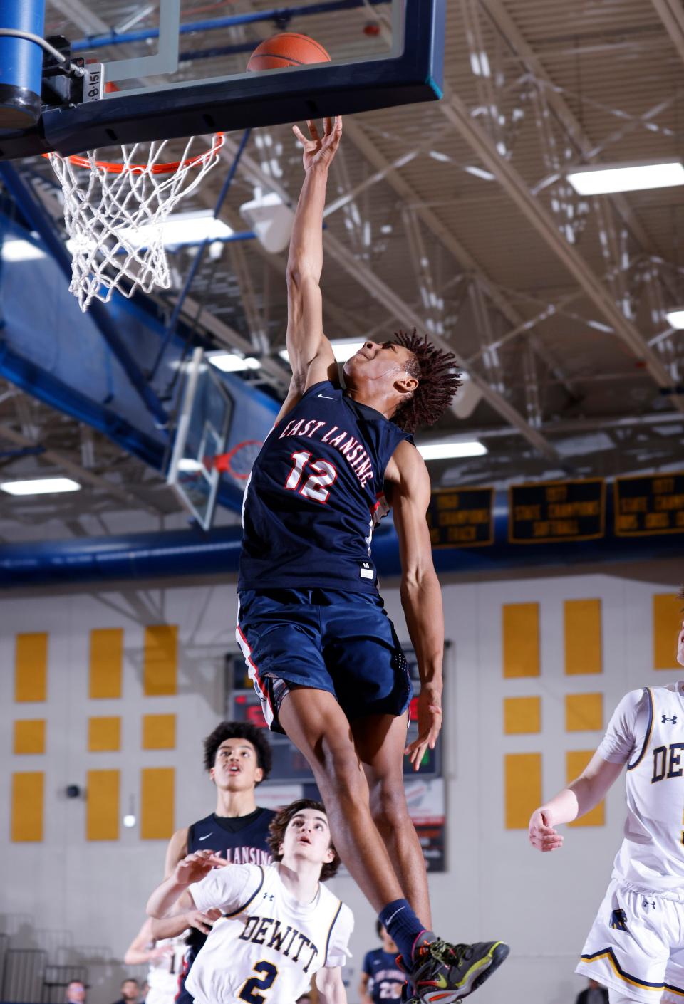 East Lansing's JL Branson (12) puts up a shot against DeWitt, Friday, Feb. 17, 2023, at DeWitt High School.