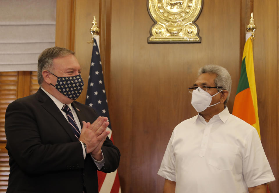 U.S. Secretary of State Mike Pompeo greets Sri Lankan President Gotabaya Rajapksa before their meeting in Colombo, Sri Lanka, Wednesday, Oct. 28, 2020. Pompeo plans to press Sri Lanka to push back against Chinese assertiveness, which U.S. officials complain is highlighted by predatory lending and development projects that benefit China more than the presumed recipients. The Chinese Embassy in Sri Lanka denounced Pompeo’s visit to the island even before he arrived there, denouncing a senior U.S. official’s warning that the country should be wary of Chinese investment. (AP Photo/Eranga Jayawardena, Pool)