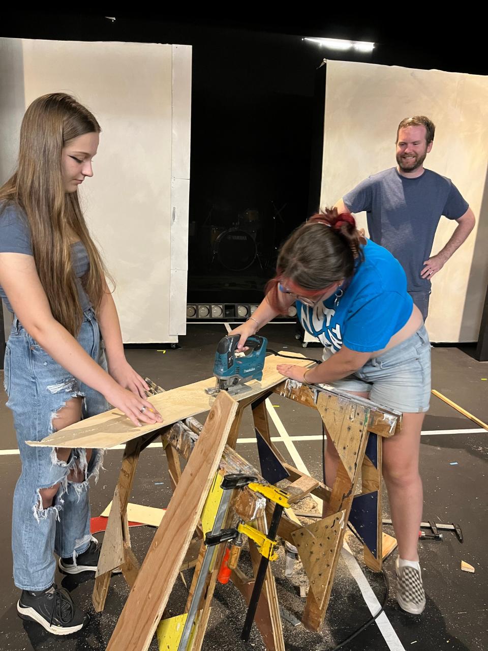 Students try their hand at set-building while an instructor is close by at Cape Cod Theatre Company's summer workshop.