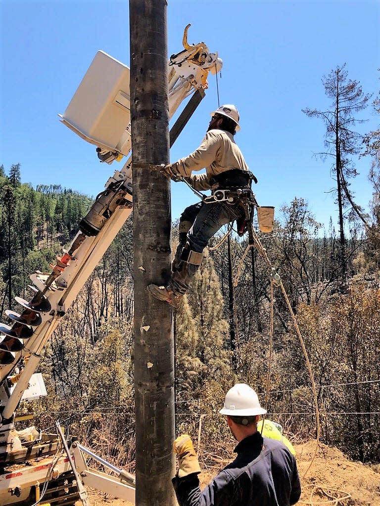 Pacific Gas and Electric crews rebuild power poles near Statton Road in Lakehead on July 8, 2021.