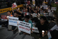 South Korean protesters react during a rally about the General Security of Military Information Agreement, or GSOMIA, in front of Japanese embassy in Seoul, South Korea, Thursday, Aug. 22, 2019. South Korea said Thursday it will terminate an intelligence-sharing deal with Japan that focused on classified information about North Korea, a surprise announcement that is likely to set back U.S. efforts to bolster security cooperation with two of its most important allies in the Asian region. The sign read "No Abe." and "Welcome, termination of GSOMIA." and "The scrapping of the South Korea-Japan deal is a people's victory." (AP Photo/Lee Jin-man)