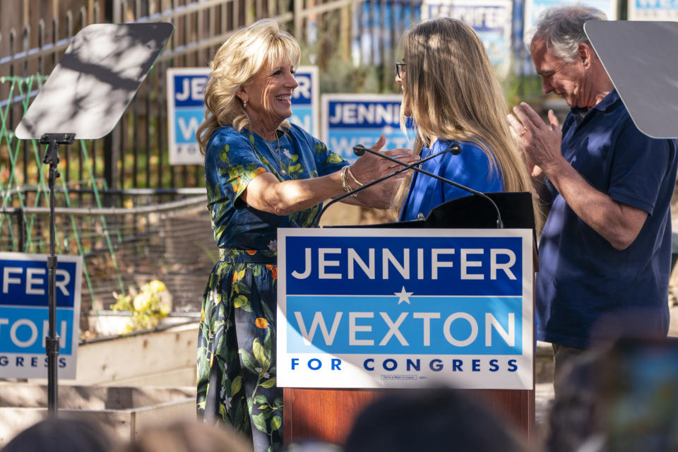 First lady Jill Biden, left, hugs Rep. Jennifer Wexton, D-Va., right, next to Sen. Tim Kaine, D-Va., at an event for Wexton in Ashburn, Va., Monday, Nov. 7, 2022. (AP Photo/Jacquelyn Martin)