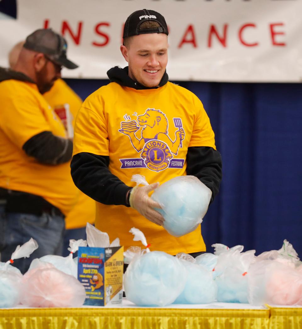 Texas Tech School of Law student Bronson Phillips packages cotton candy to be given out. The Lubbock Lions Club held their 72nd Annual Pancake Festival at the Lubbock Memorial Civic Center Saturday, Feb. 17, 2024.