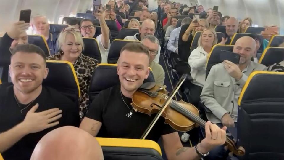 Irish folk performer Sean Magee performed for passengers while flying to the Canary Islands. Danny Walters / SWNS