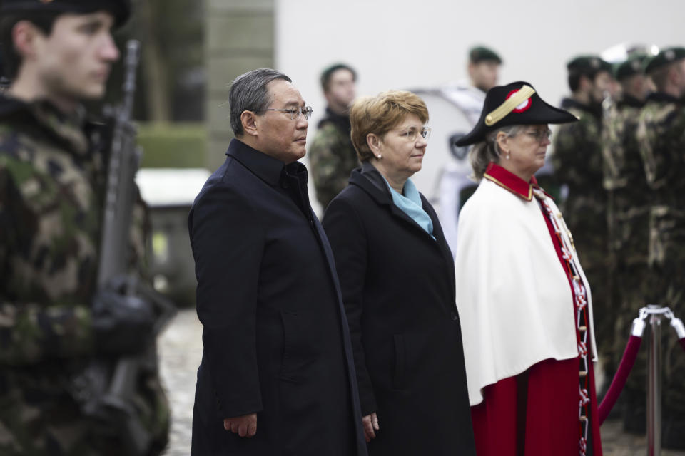Swiss President Viola Amherd, centre right, and Chinese Prime Minister Li Qiang listen to the national anthems during their meeting in Kehrsatz, near Bern, Switzerland, Monday, Jan. 15, 2024. Chinese Prime Minister Li Qiang is visiting Switzerland to attend the World Economic Forum in Davos. (Peter Klaunzer/Keystone via AP)