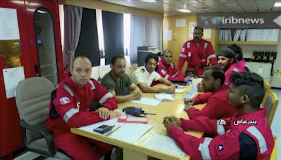 In this photo released by state-run IRIB News Agency, which aired on Monday, July 22, 2019, shows various crew members of the British-flagged tanker Stena Impero, that was seized by Tehran in the Strait of Hormuz on Friday, during a meeting. The Associated Press cannot independently verify the condition of the crew members, but in the video they looked to be in good health and it didn't appear as though they were being filmed under duress. (IRIB News Agency via AP)