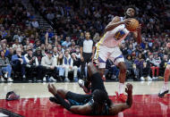 Golden State Warriors forward Andrew Wiggins (22) looks to shoot over Portland Trail Blazers forward Jerami Grant during the first half of an NBA basketball game in Portland, Ore., Wednesday, Feb. 8, 2023. (AP Photo/Craig Mitchelldyer)