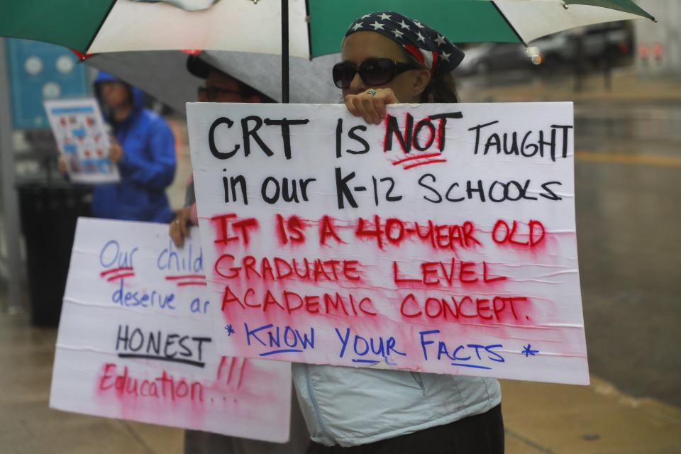 At a rally against critical race theory, counterprotesters hold signs nearby on Tuesday, Sept. 21, 2021 outside the State Board of Education in Columbus, Ohio.