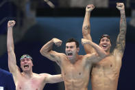 CORRECTS TO BECKER FROM BECK - United States men's 4x100m freestyle relay team Bowen Becker, Blake Pieroni, and Caeleb Dressel celebrate after winning the gold medal at the 2020 Summer Olympics, Monday, July 26, 2021, in Tokyo, Japan. (AP Photo/Matthias Schrader)