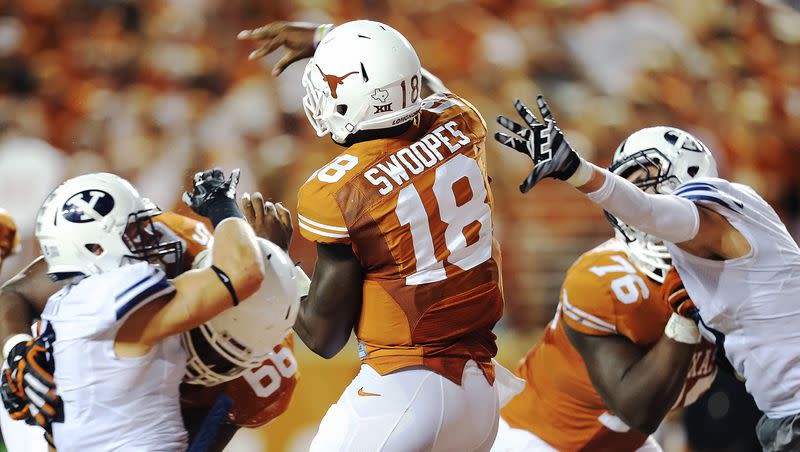 Texas quarterback Tyrone Swoopes is pressured by the BYU defense as BYU and Texas play Saturday, Sept. 6, 2014, in Austin, Texas. The Cougars conclude their October “Texas three-step” at Texas on Oct. 28, 2023.