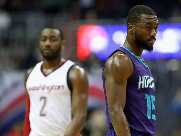 John Wall (obscured) and Kemba Walker (same). (Getty Images)