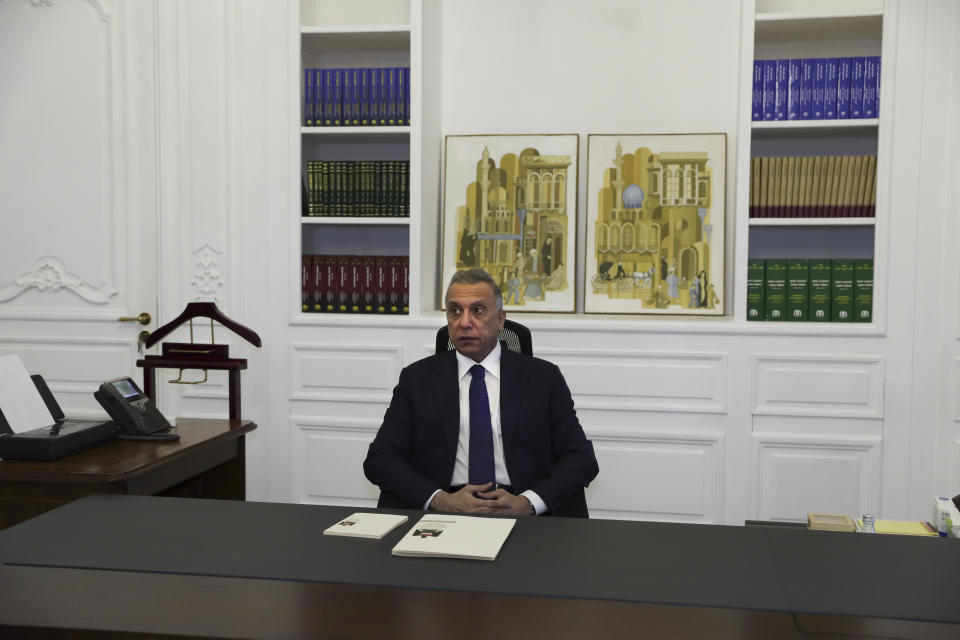 Iraqi Prime Minister Mustafa al-Kadhimi poses in his office during an interview with The Associated Press in Baghdad, Iraq, Friday, July 23, 2021. (AP Photo/Khalid Mohammed)