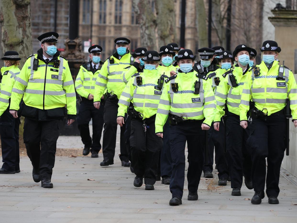 Officers patrol outside New Scotland Yard in London as members of the public gathered for a protest following clashes between police and crowds at a vigil for Sarah Everard on Clapham Common (PA)