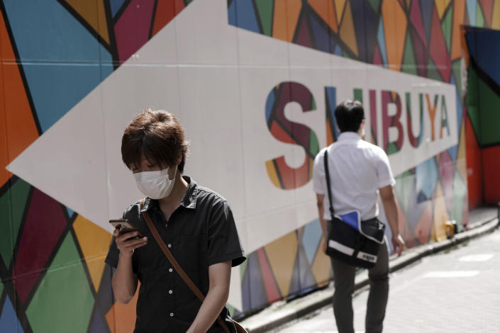 A man wearing a protective mask to help curb the spread of the coronavirus walks at a backstreet at Shibuya district Thursday, Sept. 30, 2021, in Tokyo. Fumio Kishida, the man soon to become Japan’s next prime minister, says he believes raising incomes is the only way to get the world’s third-largest economy growing again. Top of Kishida’s to-do list is another big dose of government spending to help Japan recover from the COVID-19 shock. (AP Photo/Eugene Hoshiko)