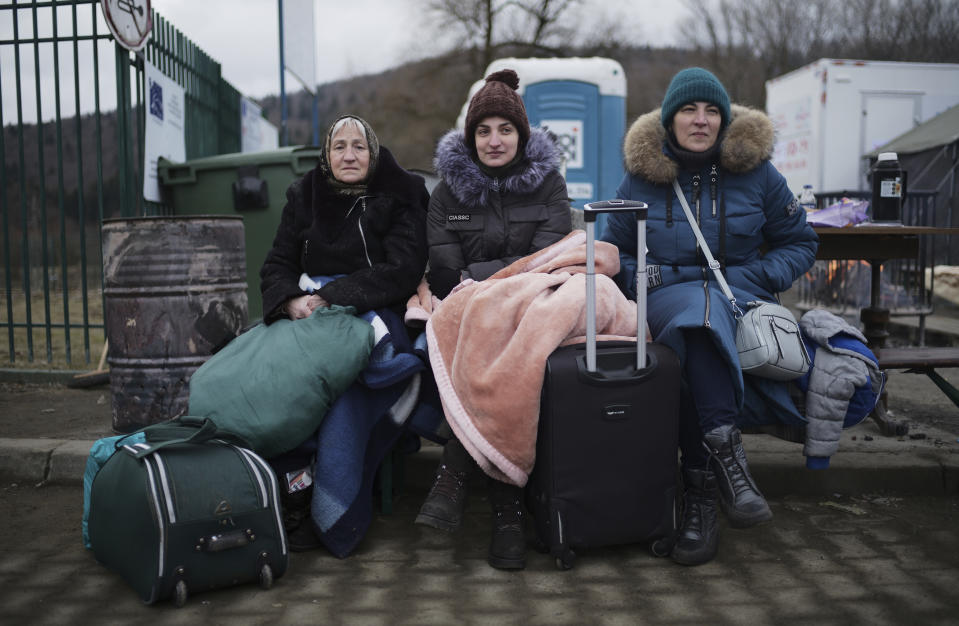 Three generations of women from left, Svetlana, Lisa and Ludmilla who fled from Odessa, Ukraine, sit at the border crossing in Kroscienko, Poland, Tuesday, March 8, 2022. U.N. officials said Tuesday that the Russian onslaught has forced 2 million people to flee Ukraine. It has trapped others inside besieged cities that are running low on food, water and medicine amid the biggest ground war in Europe since World War II. (AP Photo/Markus Schreiber)