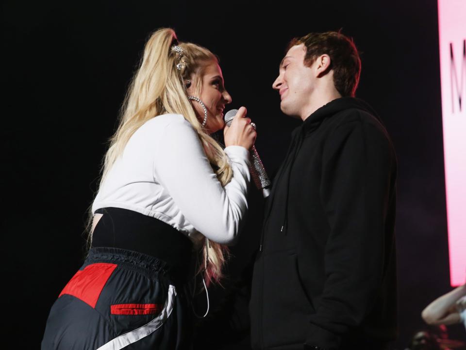 meghan trainor singing to her husband daryl sabara onstage. they're making eye contact, and he has a sappy look on his face as he gazes at her