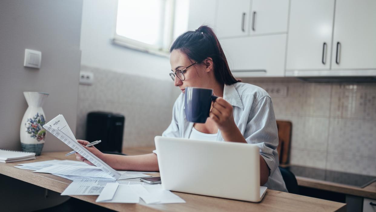 Young wife working at home.