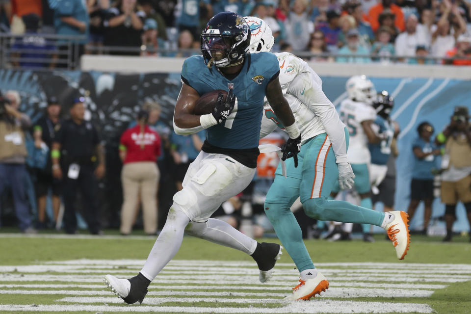 Jacksonville Jaguars running back Travis Etienne Jr. (1) runs into the endzone to score a touchdown during the first half of an NFL preseason football game against the Miami Dolphins, Saturday, Aug. 26, 2023, in Jacksonville, Fla. (AP Photo/Gary McCullough)