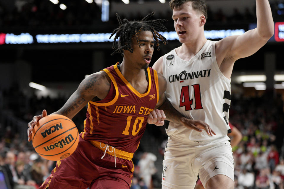 Iowa State guard Keshon Gilbert (10) drives against Cincinnati's Simas Lukosius (41) during the second half of an NCAA college basketball game, Tuesday, Feb. 13, 2024, in Cincinnati. (AP Photo/Jeff Dean)